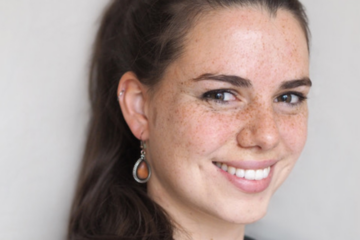 Franziska Holtzhausen. Frau mit langen braunen Haaren, Sommersprossen und Ohrringen. Zuständig für Beratung, Coaching & Supervision.